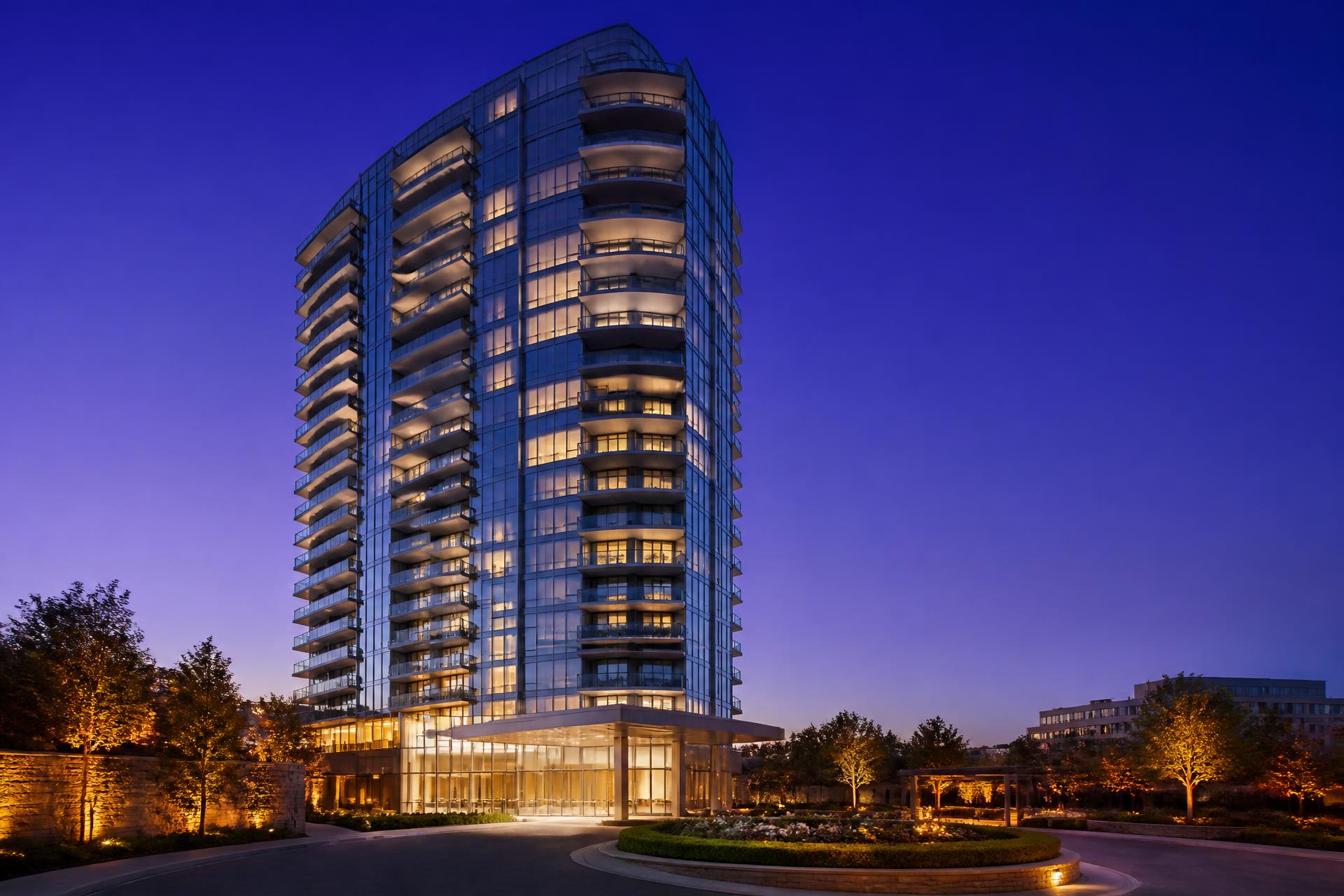 Illuminated modern residential tower at dusk